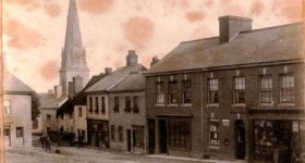 Picture of Uffculme Square, south side with St Mary's Church Spire in background. Devon. Undated.